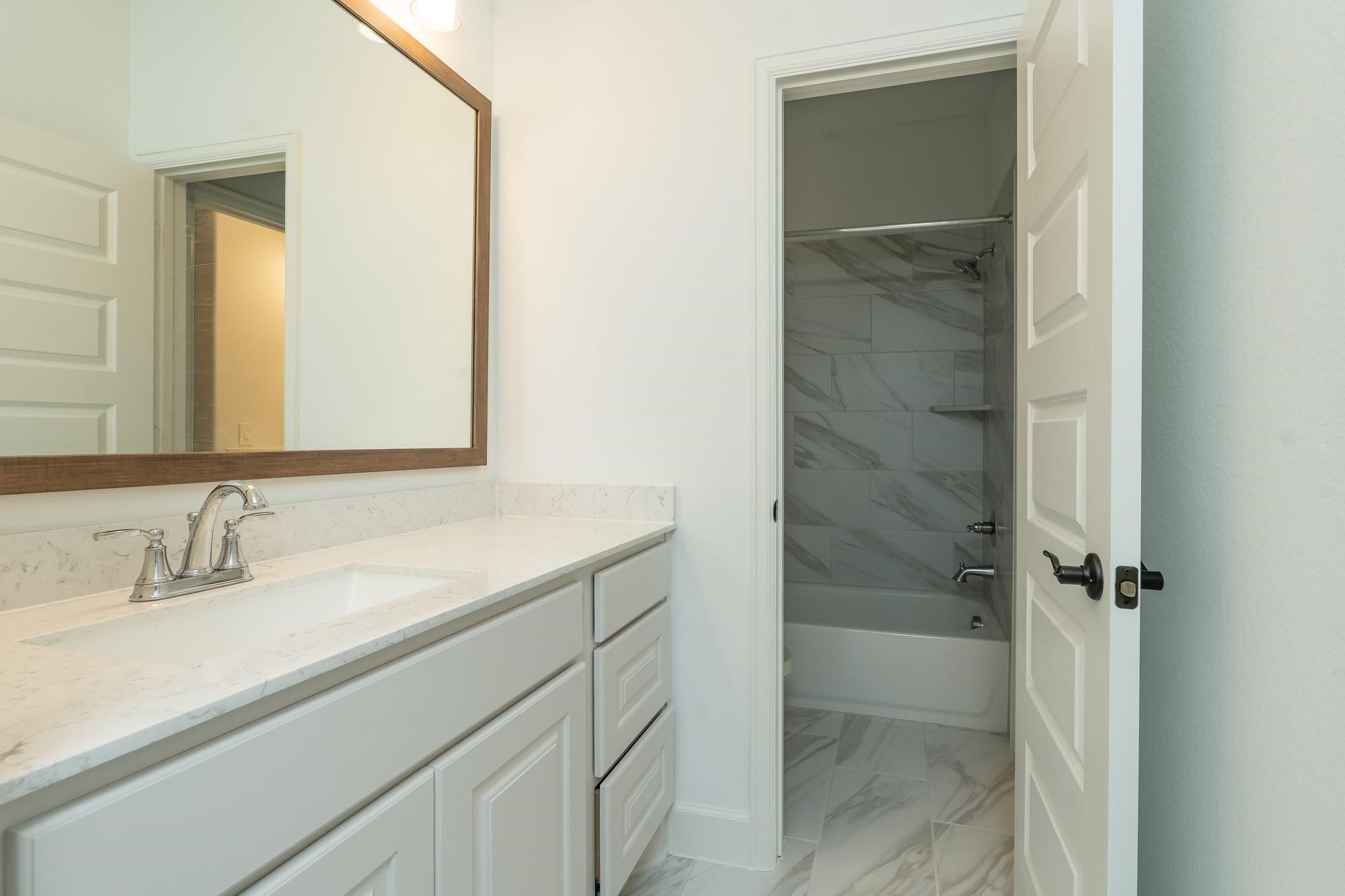 4118 Ana Ridge Lane Fulshear, TX 77441 - Photo 35 of 49 a bathroom with a sink and a mirror