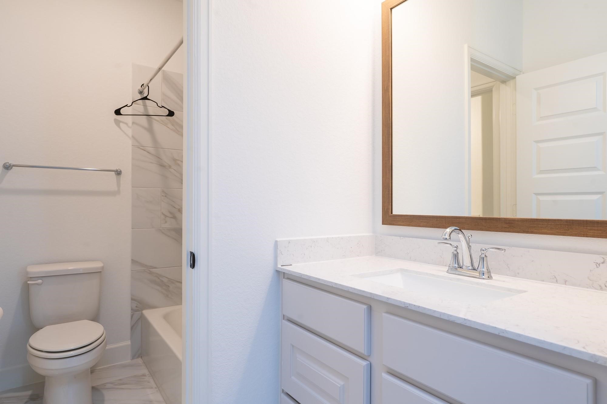 4118 Ana Ridge Lane Fulshear, TX 77441 - Photo 38 of 49 a bathroom with a sink toilet and shower