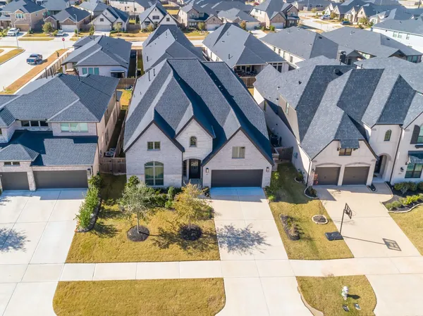 an aerial view of a house with a yard