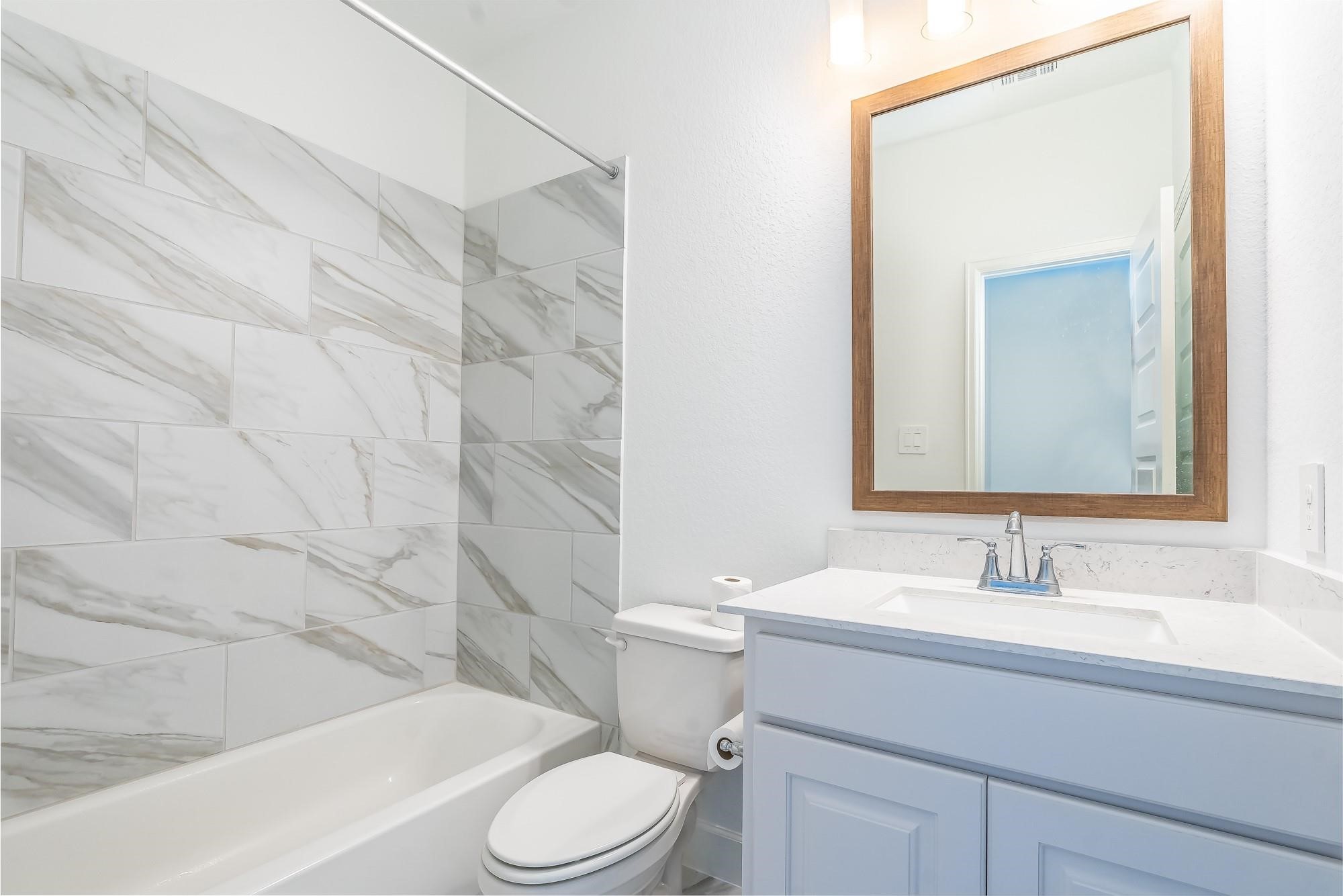 4118 Ana Ridge Lane Fulshear, TX 77441 - Photo 45 of 49 a bathroom with a sink a toilet and shower