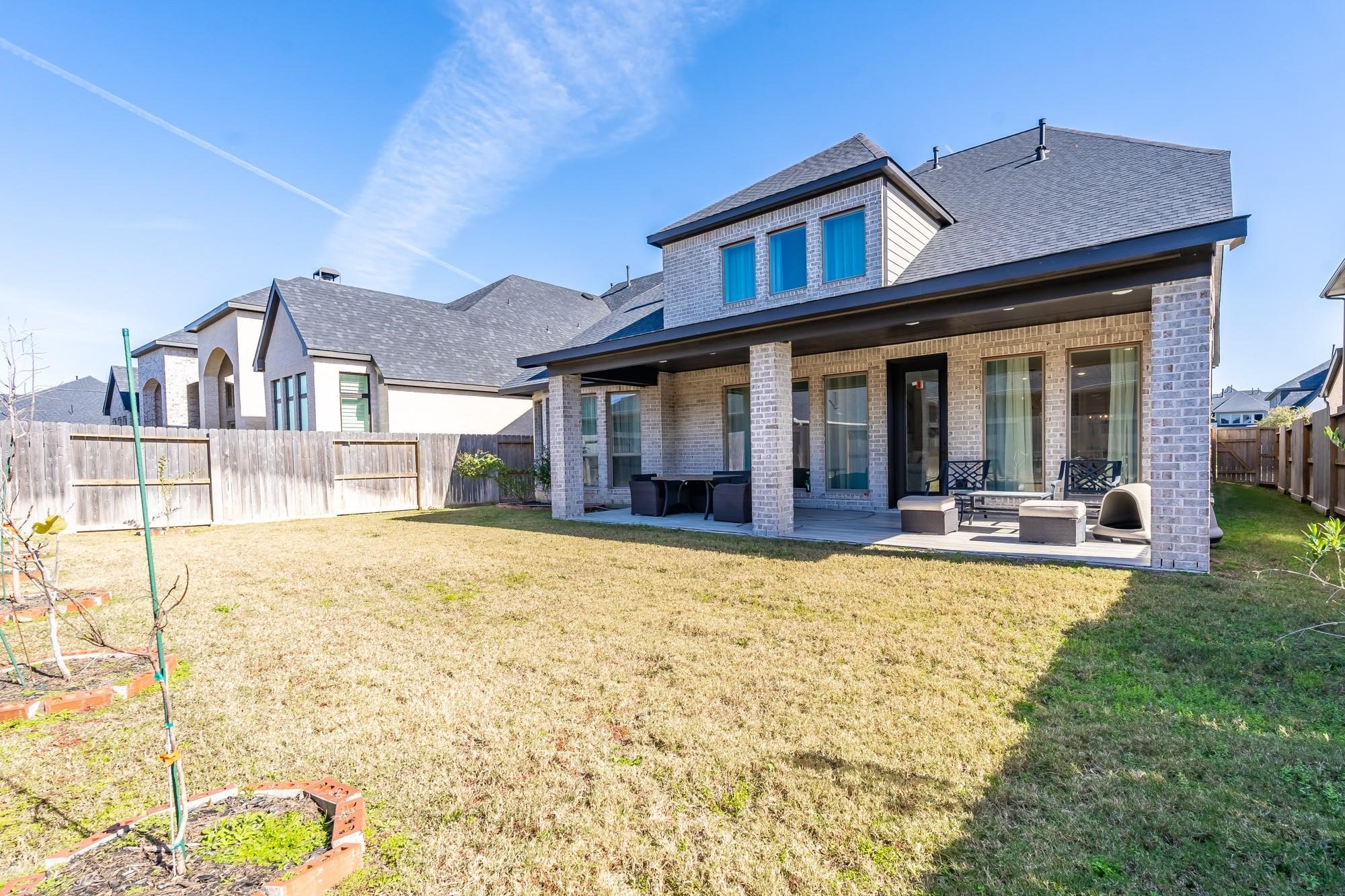 4118 Ana Ridge Lane Fulshear, TX 77441 - Photo 47 of 49 a front view of a house with swimming pool and a garden