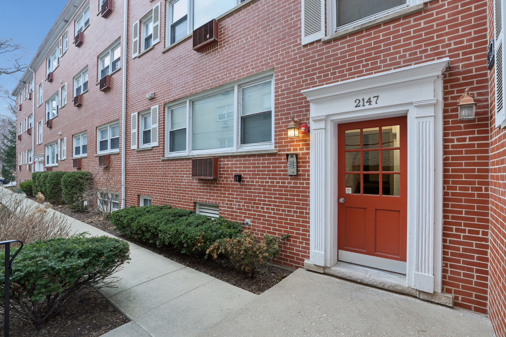 2147 Ridge Avenue, Unit 2D Evanston, IL 60201 - Photo 2 of 22 a view of a brick house with a yard