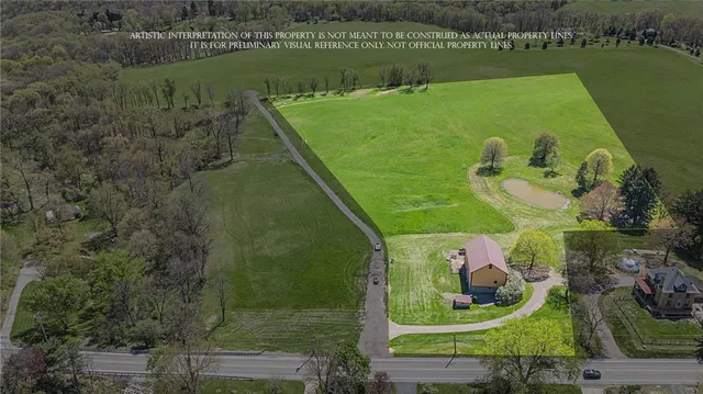 an aerial view of a house with a lake view