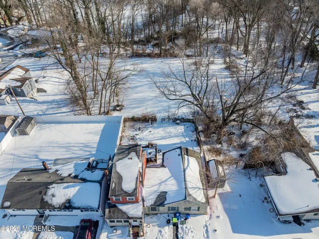 a front view of a building with a yard covered in snow