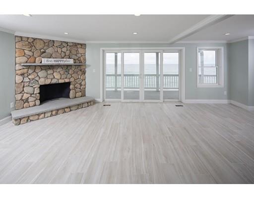 324 Ocean Street Marshfield, MA 02050 - Photo 2 of 25 a view of an empty room with a fireplace and a window