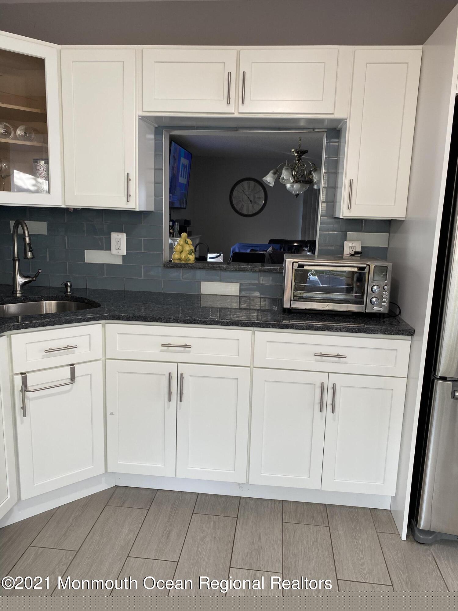 60 County Road, Unit D023 Cliffwood, NJ 07721 - Photo 12 of 36 a kitchen with stainless steel appliances granite countertop a sink and a microwave