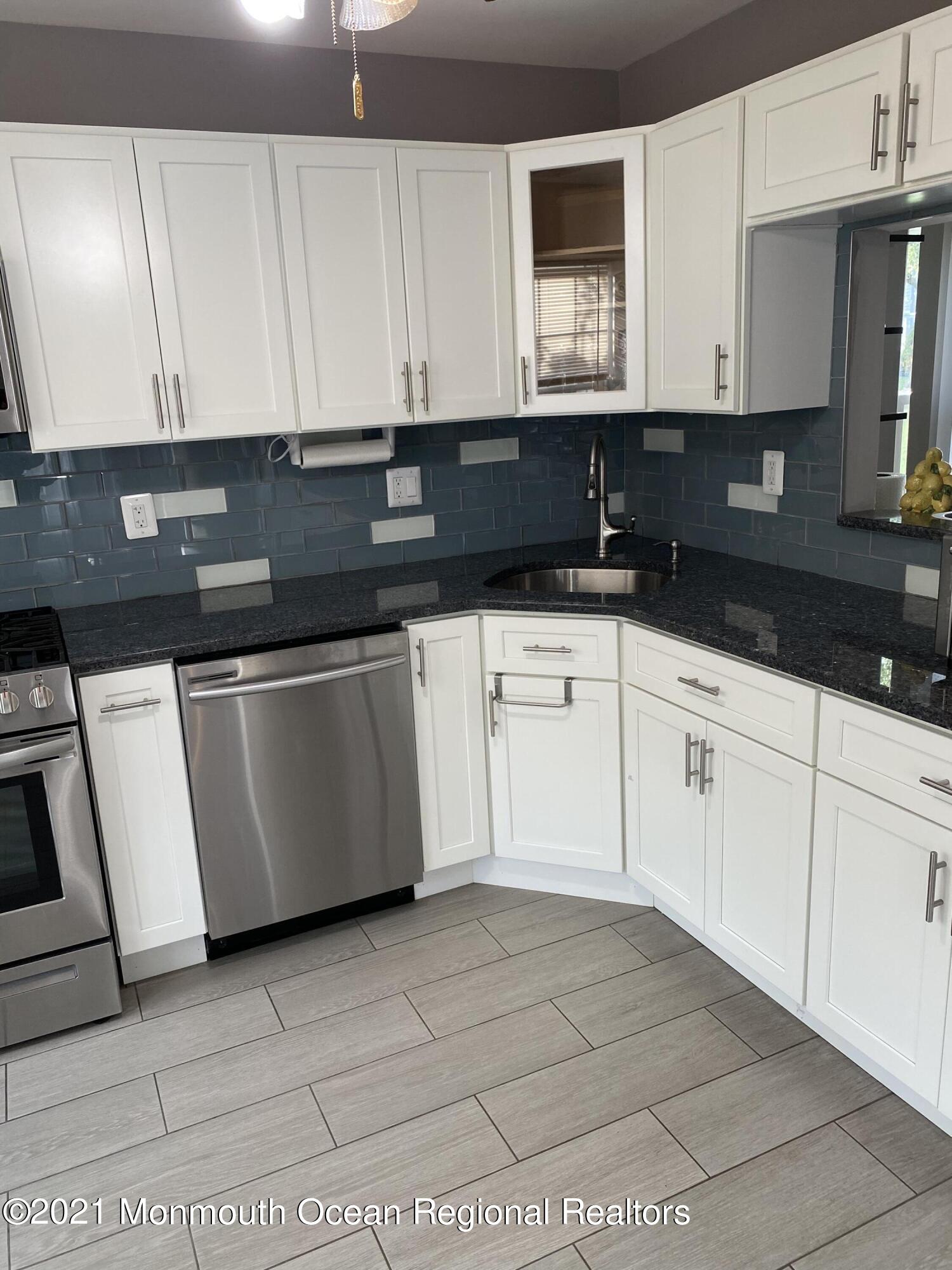 60 County Road, Unit D023 Cliffwood, NJ 07721 - Photo 16 of 36 a kitchen with granite countertop white cabinets and sink