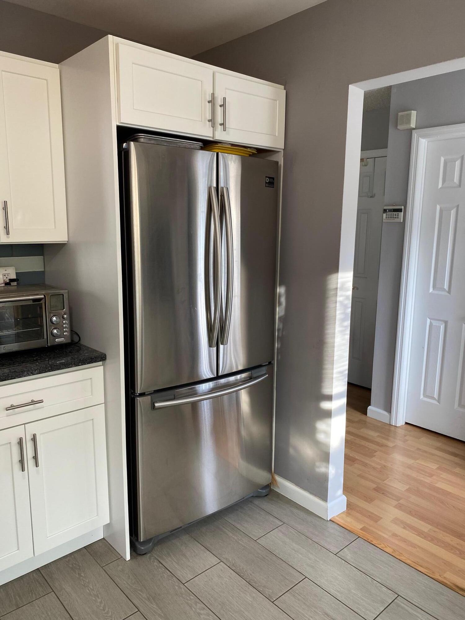 60 County Road, Unit D023 Cliffwood, NJ 07721 - Photo 17 of 36 a metallic refrigerator freezer and a stove sitting inside of a kitchen