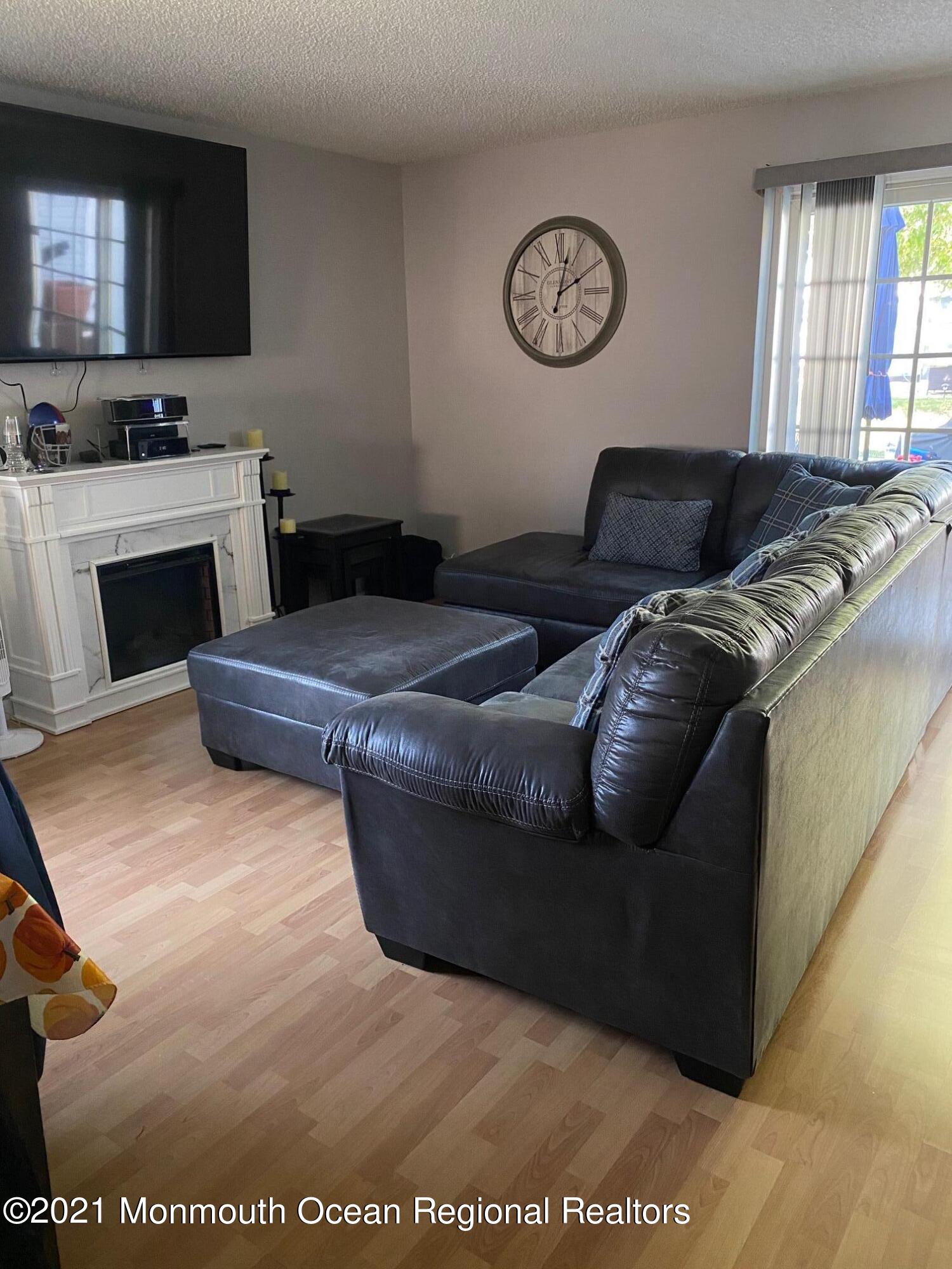 60 County Road, Unit D023 Cliffwood, NJ 07721 - Photo 18 of 36 a living room with furniture and a flat screen tv