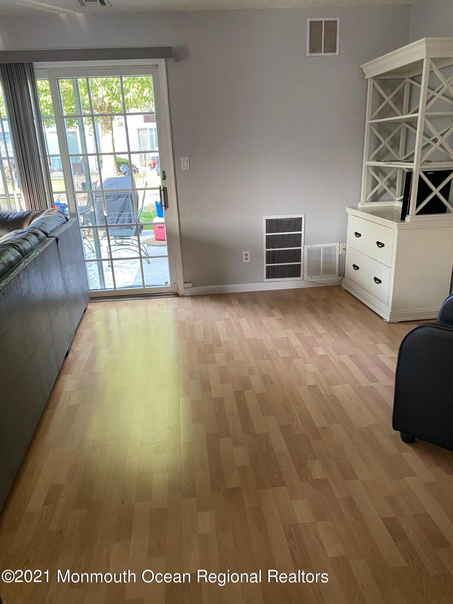 60 County Road, Unit D023 Cliffwood, NJ 07721 - Photo 20 of 36 a view of room with window and hardwood floor
