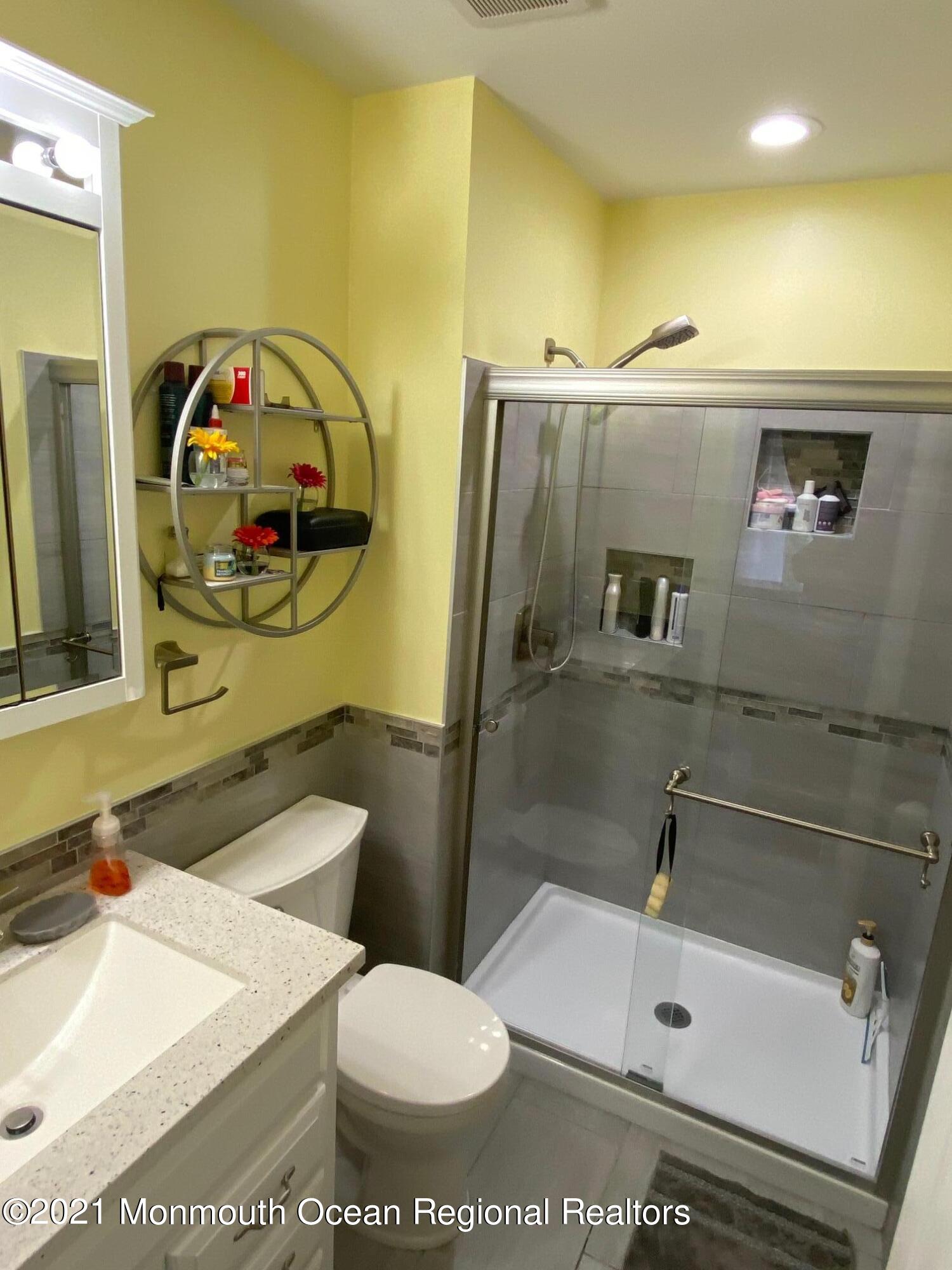 60 County Road, Unit D023 Cliffwood, NJ 07721 - Photo 36 of 36 a bathroom with a sink a toilet and shower