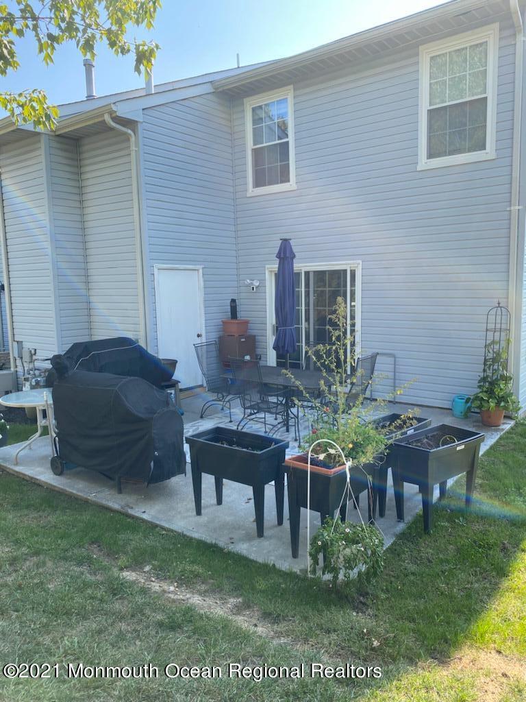 60 County Road, Unit D023 Cliffwood, NJ 07721 - Photo 7 of 36 a view of a chairs and table in patio
