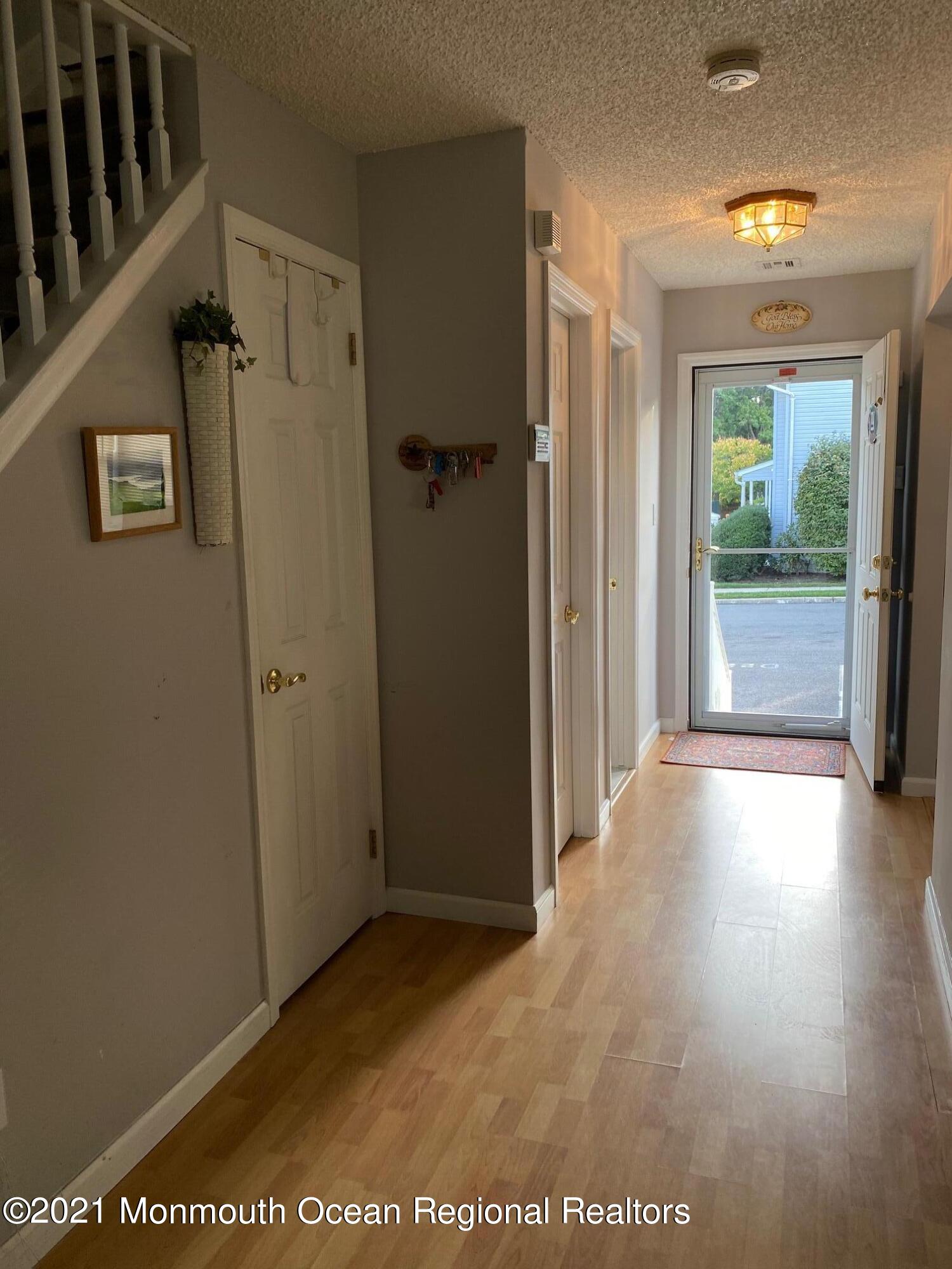 60 County Road, Unit D023 Cliffwood, NJ 07721 - Photo 9 of 36 a view of a hallway with wooden floor and a bathroom