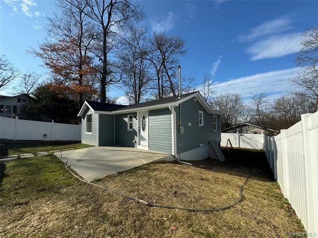 a view of a house with a yard and garage