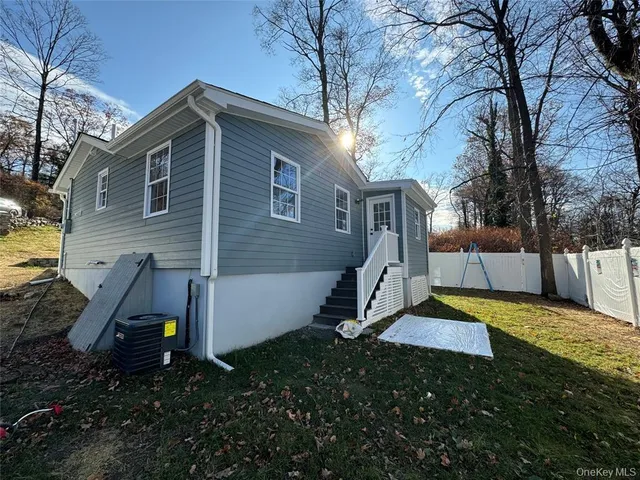 a view of backyard of house with green space