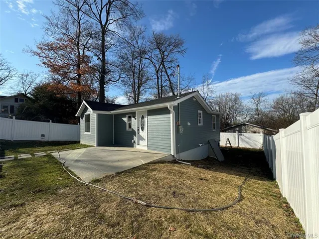 a view of a house with a yard and garage