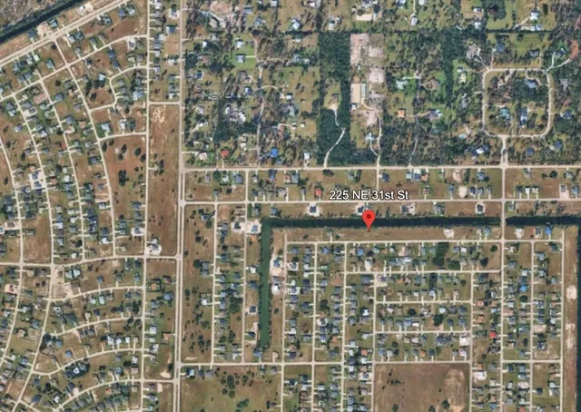 a view of a lake with houses in the back