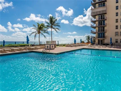 a view of swimming pool with outdoor seating