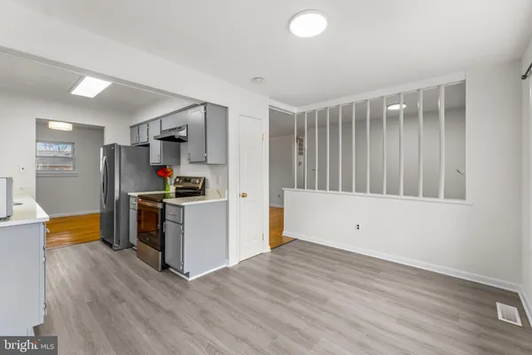 a kitchen with a refrigerator and a stove top oven