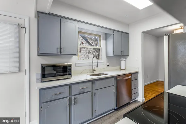 a kitchen with a sink and cabinets