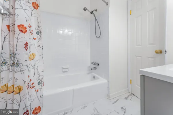 a bathroom with a bathtub and a shower