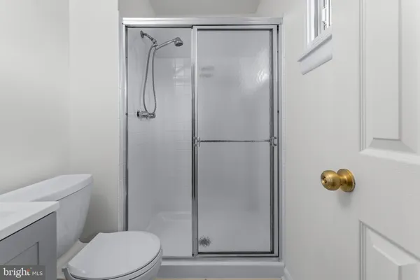 a bathroom with a shower a toilet and a sink