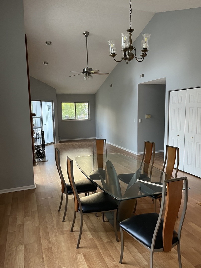 1272 Ranchview Court, Unit 1272 Buffalo Grove, IL 60089 - Photo 2 of 13 a view of a dining room with furniture and a chandelier