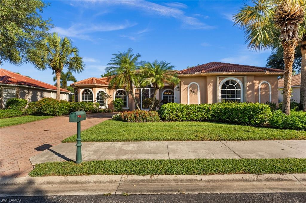 3972 Ruxton Road Naples, FL 34116 - Photo 39 of 41 a front view of a house with a yard and garage