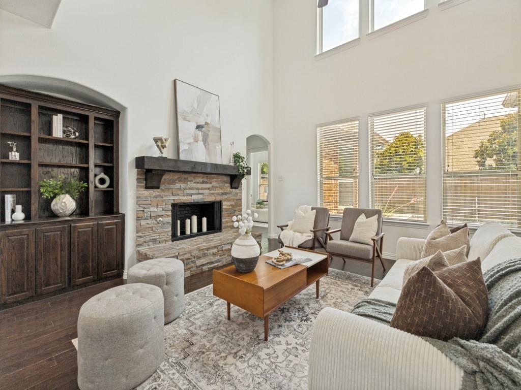 916 Redbird Lane Allen, TX 75013 - Photo 5 of 28 Rich wood built-ins next to the stacked stone fireplace with hearth.