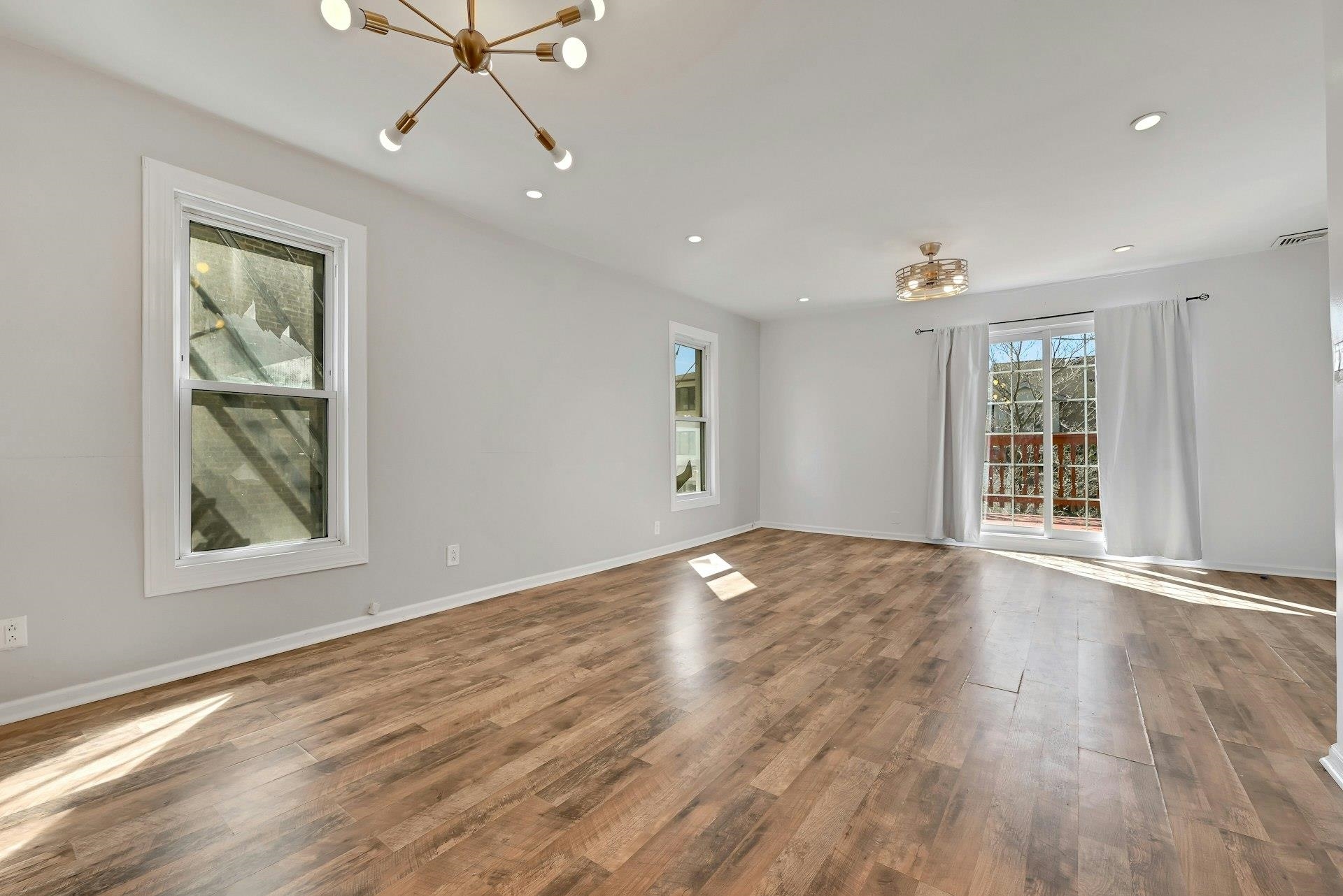 30 Columbia Terrace, Unit 2 Edgewater, NJ 07020 - Photo 3 of 25 a view of an empty room with wooden floor and a window