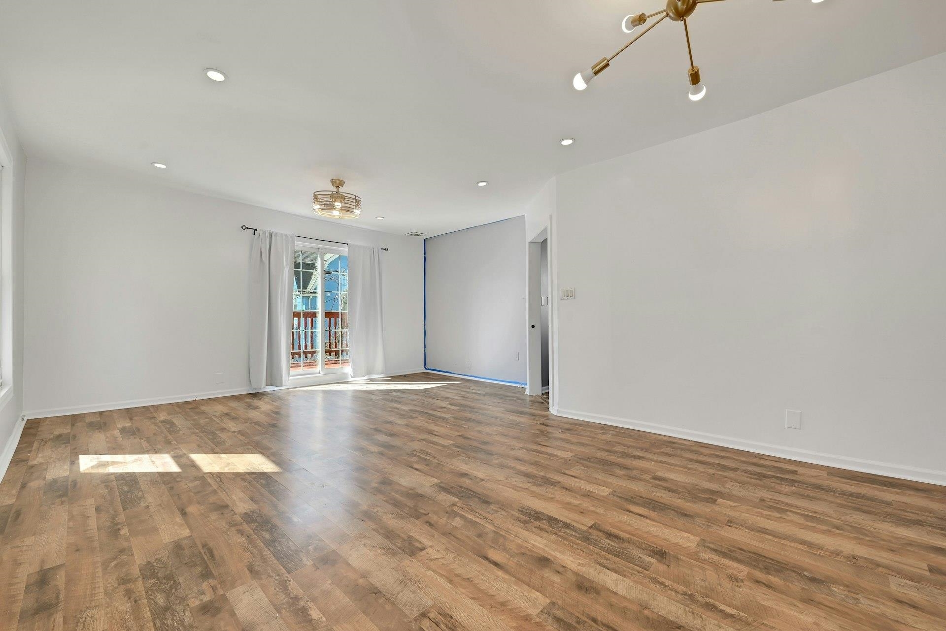 30 Columbia Terrace, Unit 2 Edgewater, NJ 07020 - Photo 10 of 25 a view of an empty room with wooden floor and windows