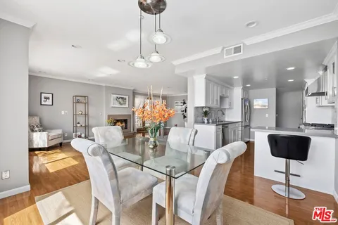 a dining room with furniture and wooden floor