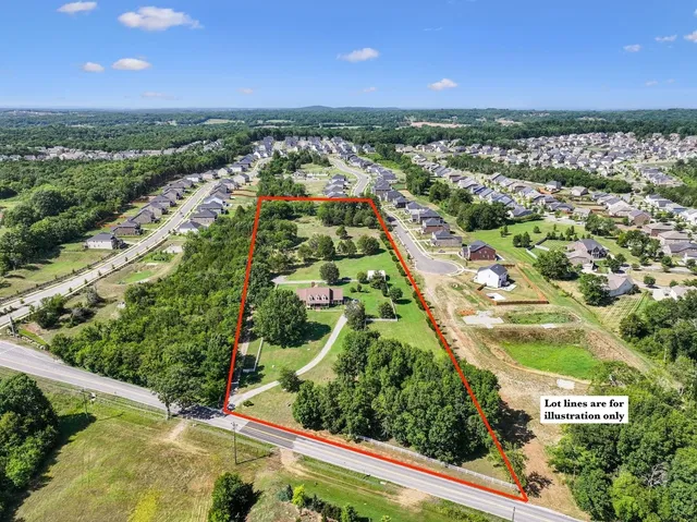 an aerial view of residential houses with outdoor space and street view