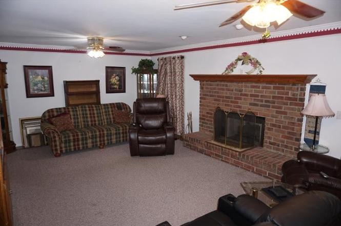 2384 Rocky Fork Road Nolensville, TN 37135 - Photo 7 of 21 a living room with furniture a fireplace and a flat screen tv