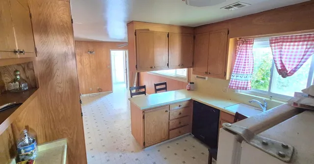a kitchen that has a sink and a stove in it