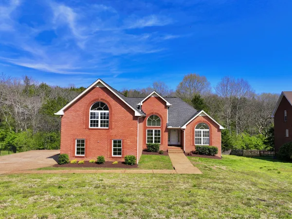a front view of a house with a yard