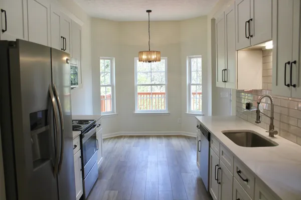 a kitchen with a sink stove and refrigerator