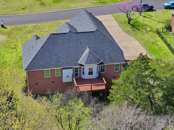 an aerial view of a house with a yard