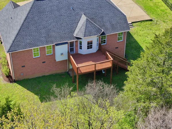 an aerial view of a house with big yard