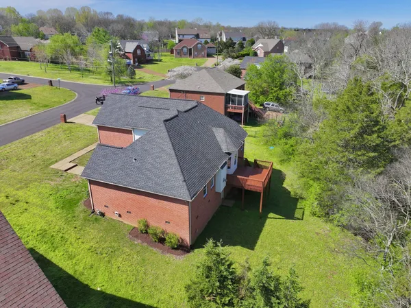 a aerial view of a house with a yard and sitting area