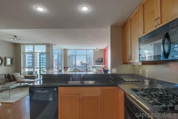 a kitchen with sink a stove and cabinets
