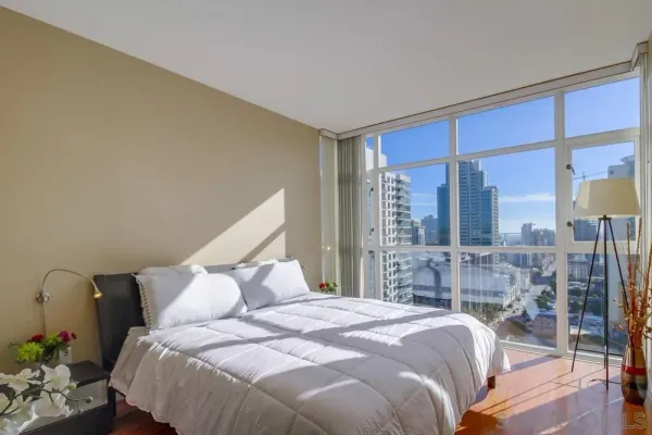 a bedroom with a large bed and a large window
