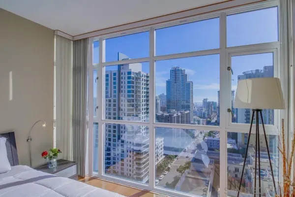 a view of a room with a floor to ceiling window and wooden floor