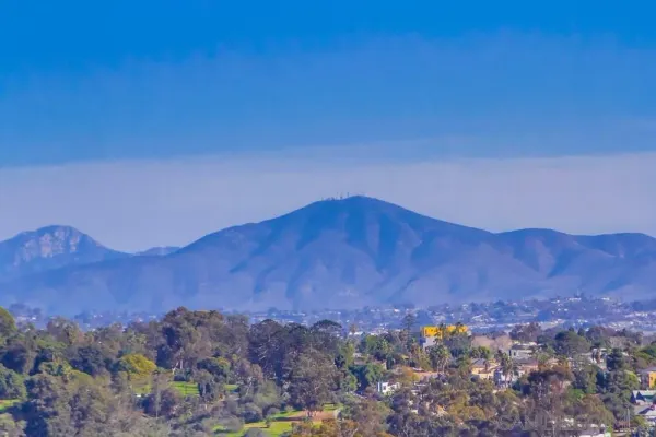 a view of a house with a mountain in the background