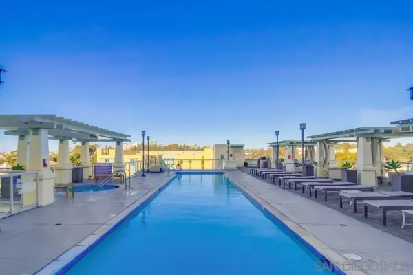 a view of a swimming pool with outdoor seating