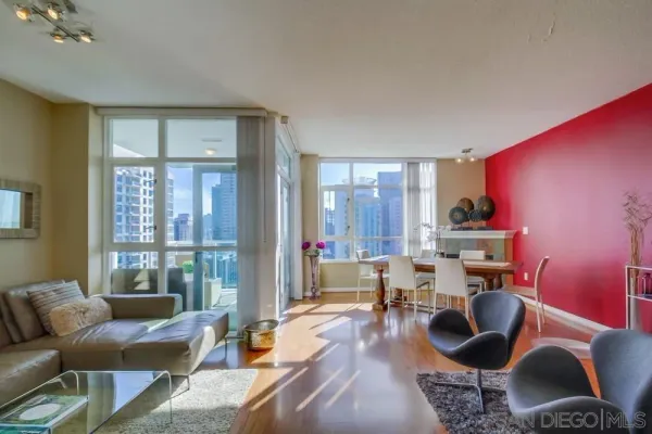 a living room with furniture and a floor to ceiling window