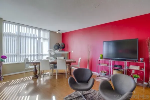 a living room with furniture a flat screen tv and a large window