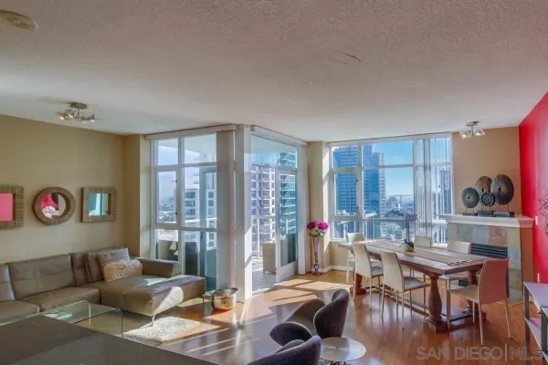 a living room with furniture and a floor to ceiling window