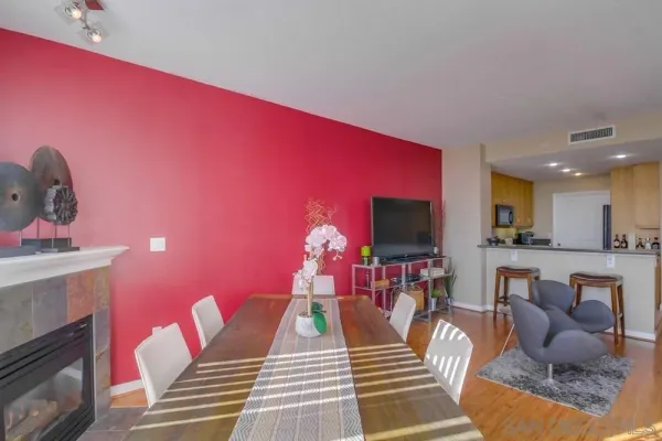a living room with furniture a flat screen tv and kitchen view