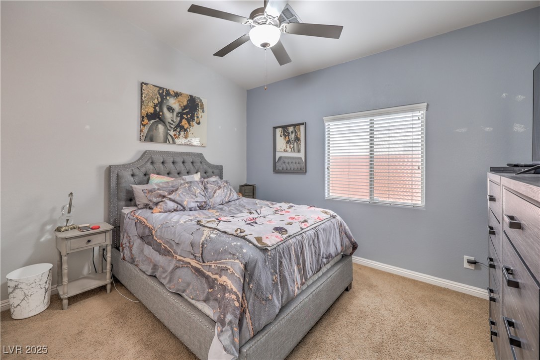 172 Turtle Ridge Avenue Las Vegas, NV 89183 - Photo 29 of 38 Bedroom with baseboards, ceiling fan, vaulted ceiling, and light carpet